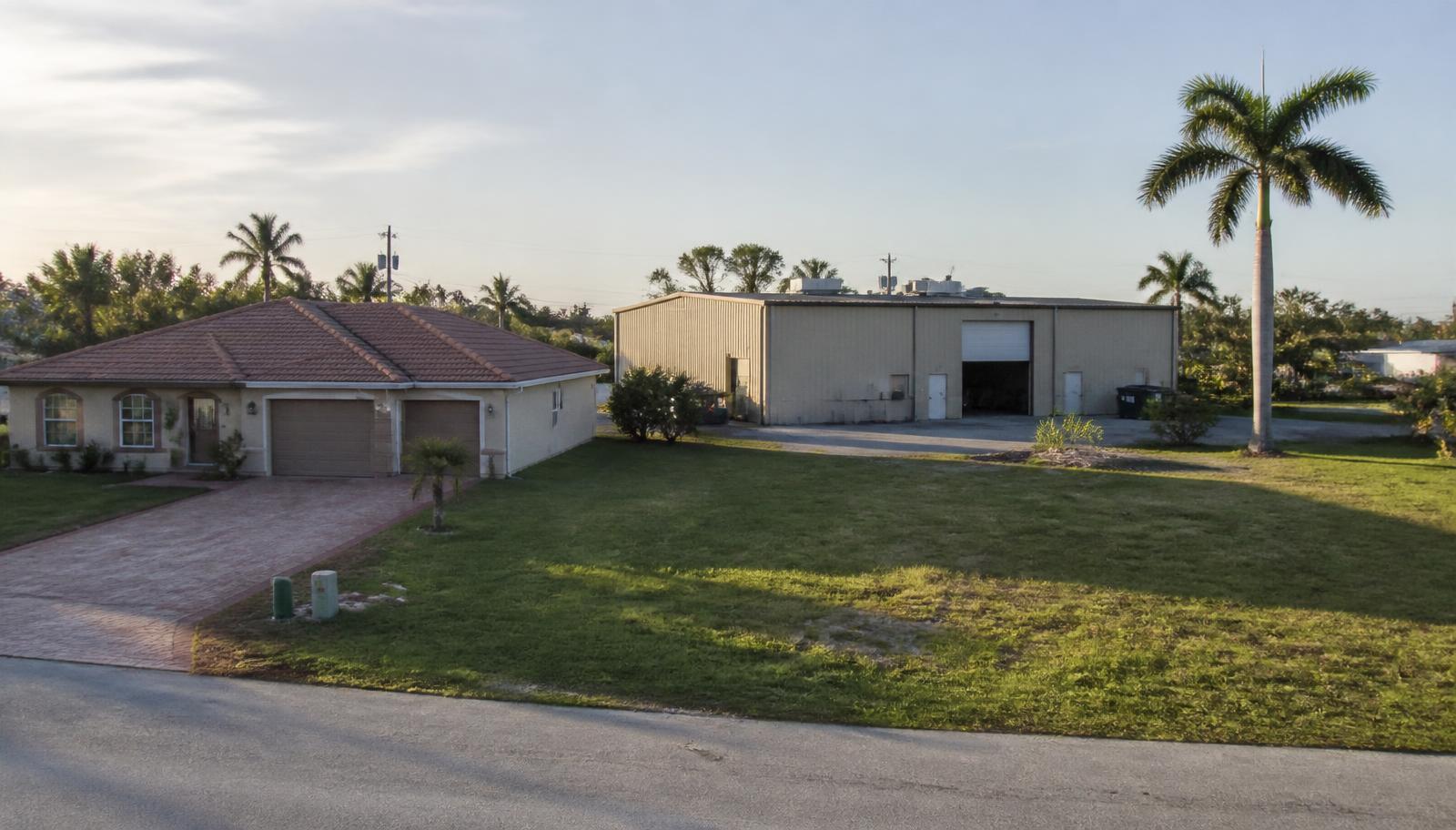 Photograph of a Florida rental home, a small commercial warehouse, and a vacant lot side by side in warm afternoon light, illustrating multiple properties pledged as collateral.