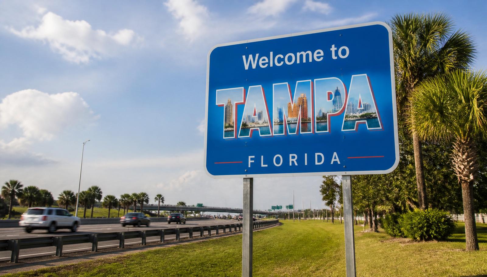 Editorial photo of the Welcome to Tampa, Florida highway sign along the interstate, highlighting Tampa's role as the northern gateway to Florida's rapidly growing Gulf Coast commercial real estate market.